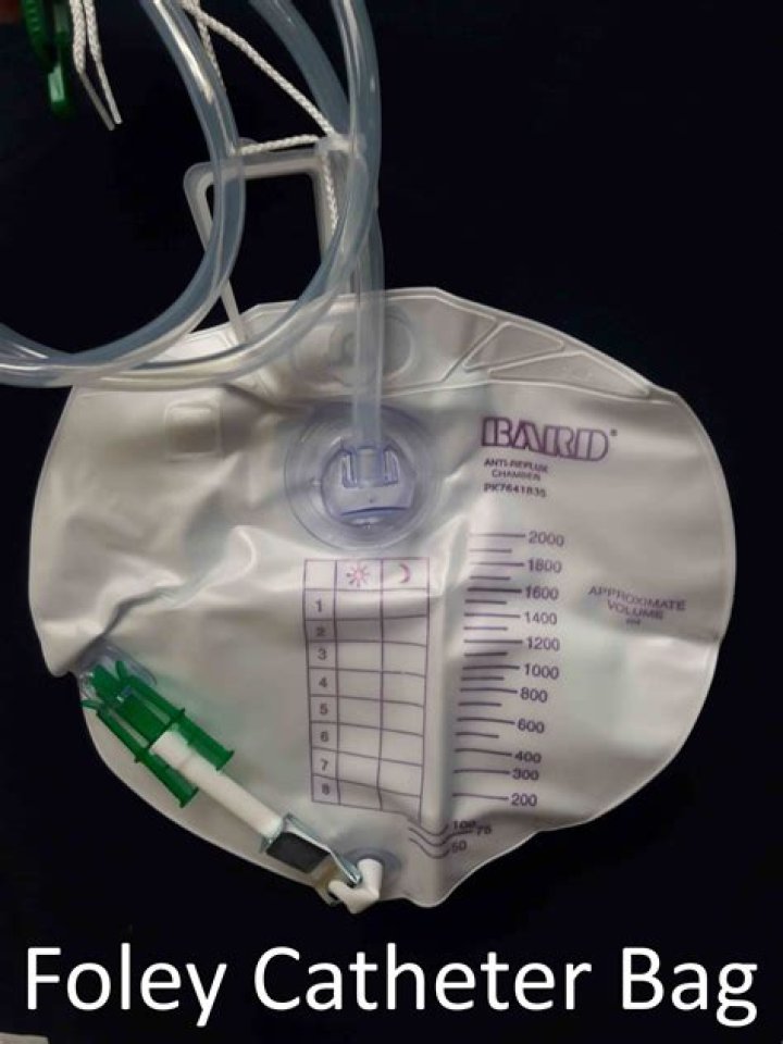 How do I empty a catheter bag?